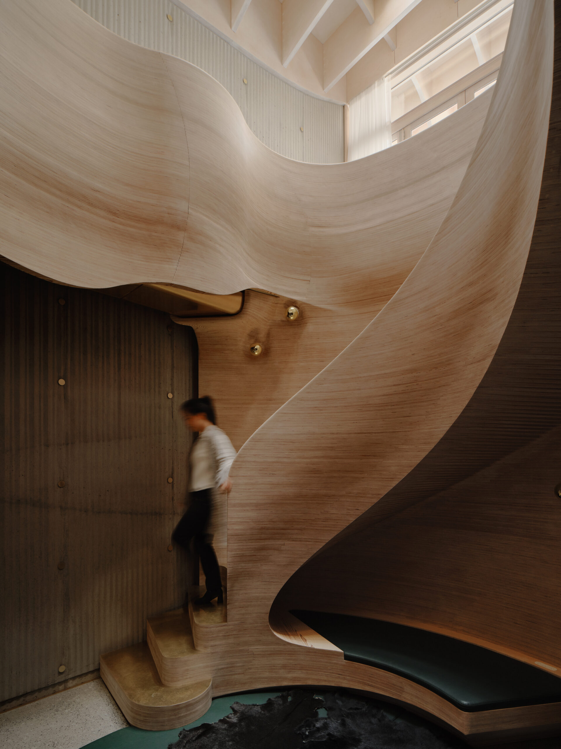 Sculptural spiral staircase at the heart of Northcote House, designed to draw daylight into the home.